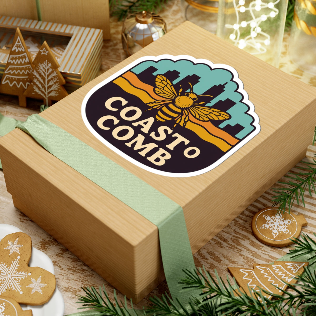 Wooden gift box with 'Coast to Comb' logo on a festive background with cookies and lights.