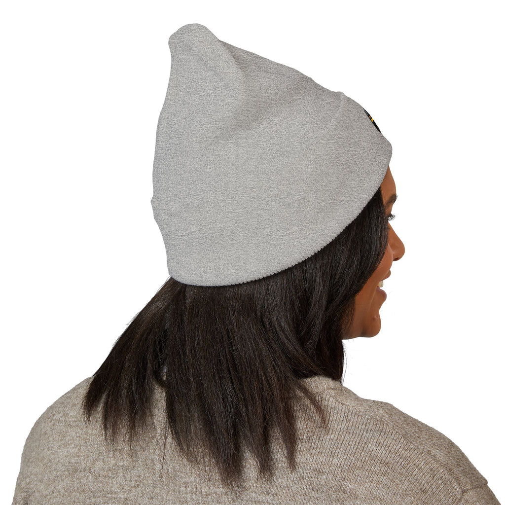 Person wearing a gray beanie on a white background