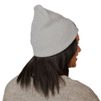 Person wearing a gray beanie on a white background