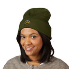 Person wearing a green beanie with a logo on a white background