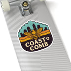 Skateboard with a 'Coasto Comb' sticker featuring a bee design on a white background