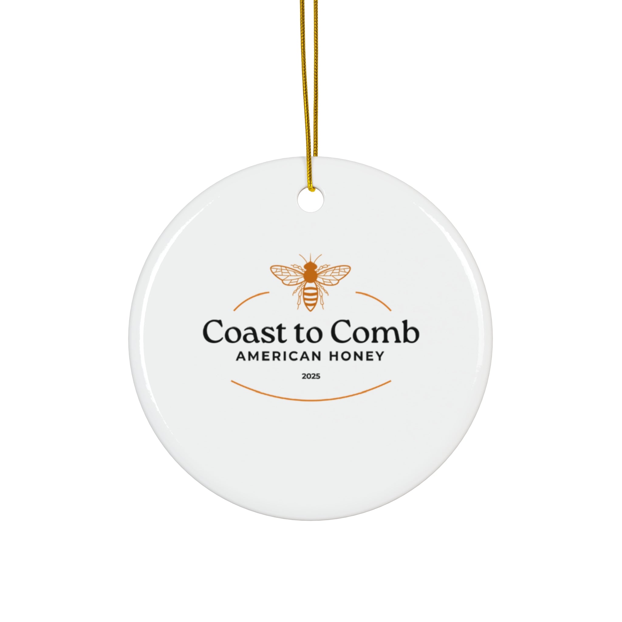 Round white ceramic ornament with 'Coast to Comb American Honey' logo on a white background