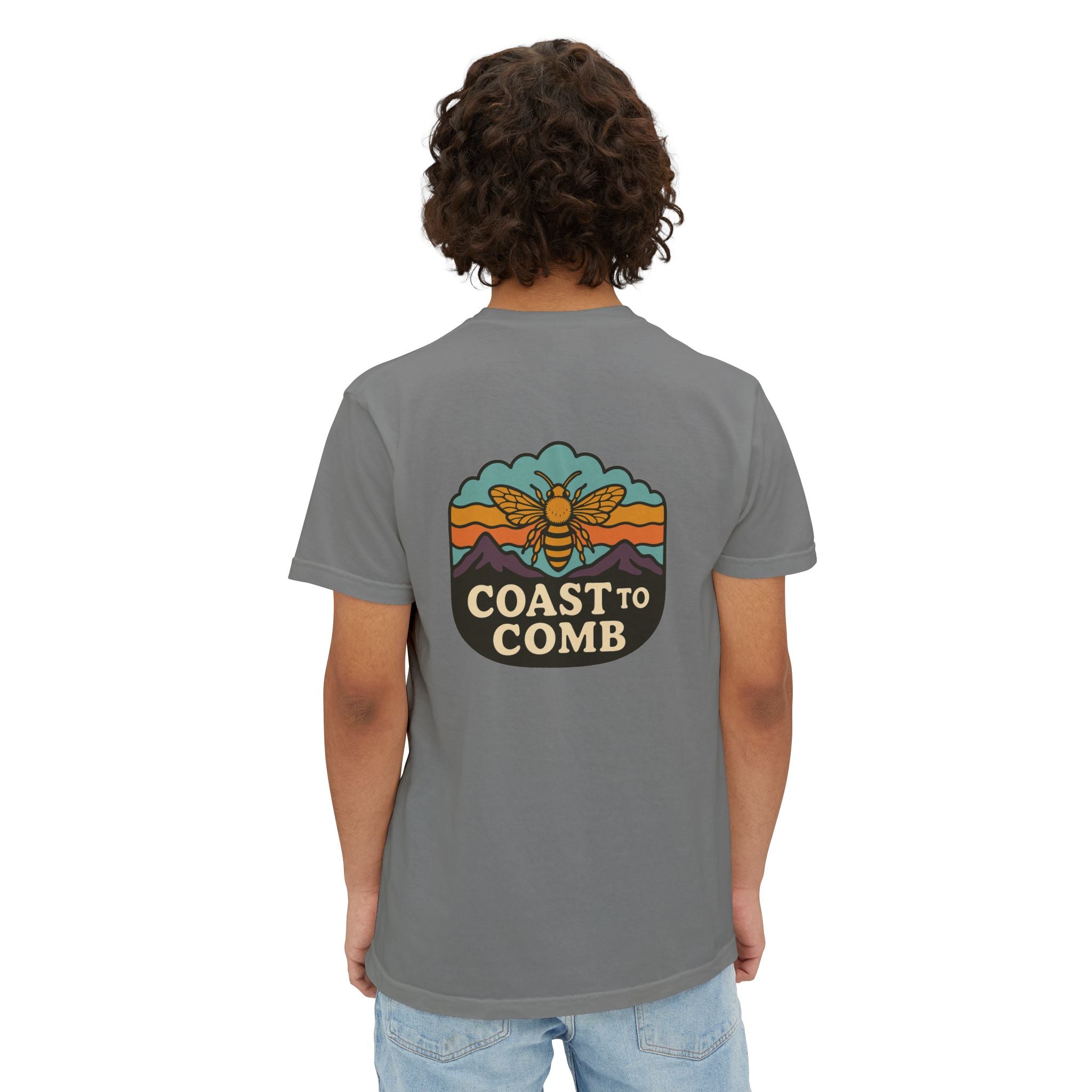 Person wearing a gray t-shirt with a 'Coast to Comb' logo on the back, standing against a white background.