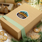 Wooden gift box with a 'Coastal Comb' sticker on a festive background with cookies and greenery.