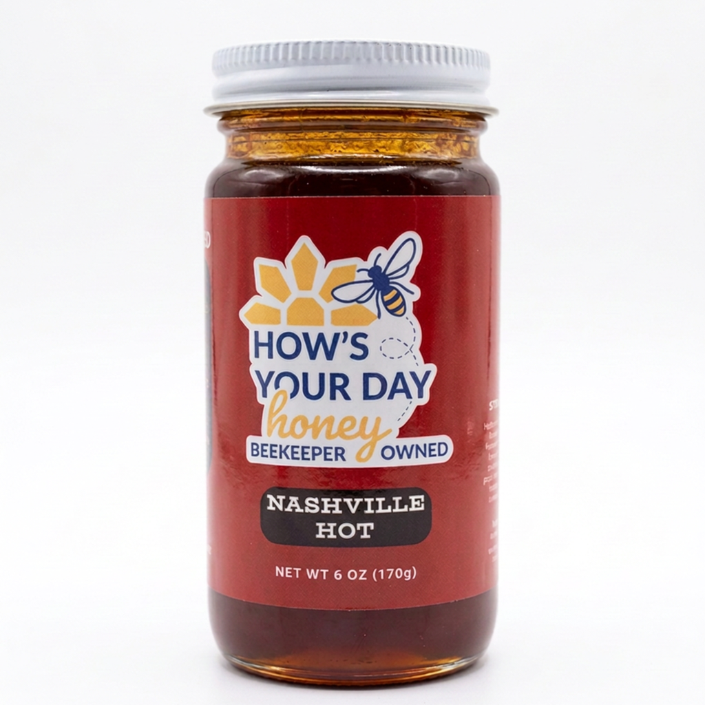 A jar of How's Your Day Honey, Nashville Hot flavor, with a red label and white lid, set against a plain white background.
