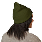 Person wearing a green beanie on a white background
