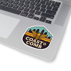 Laptop with a 'Coast to Comb' sticker featuring a bee design.