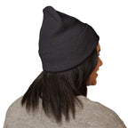Person wearing a black beanie on a white background