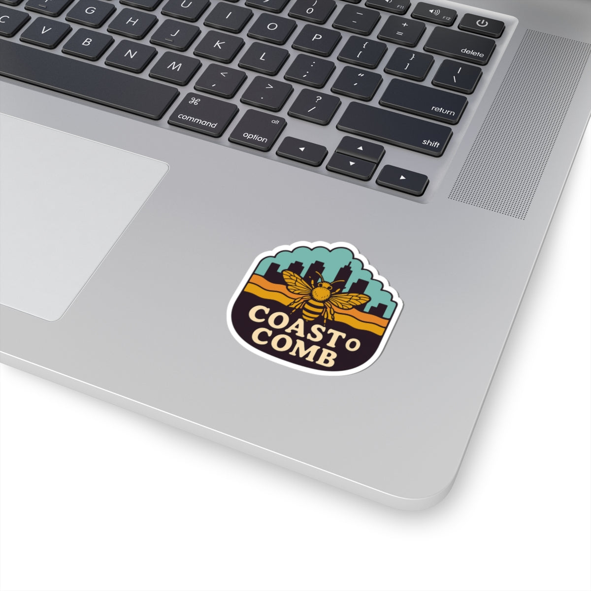 Laptop with a 'Coast o' Comb' sticker on the palm rest area