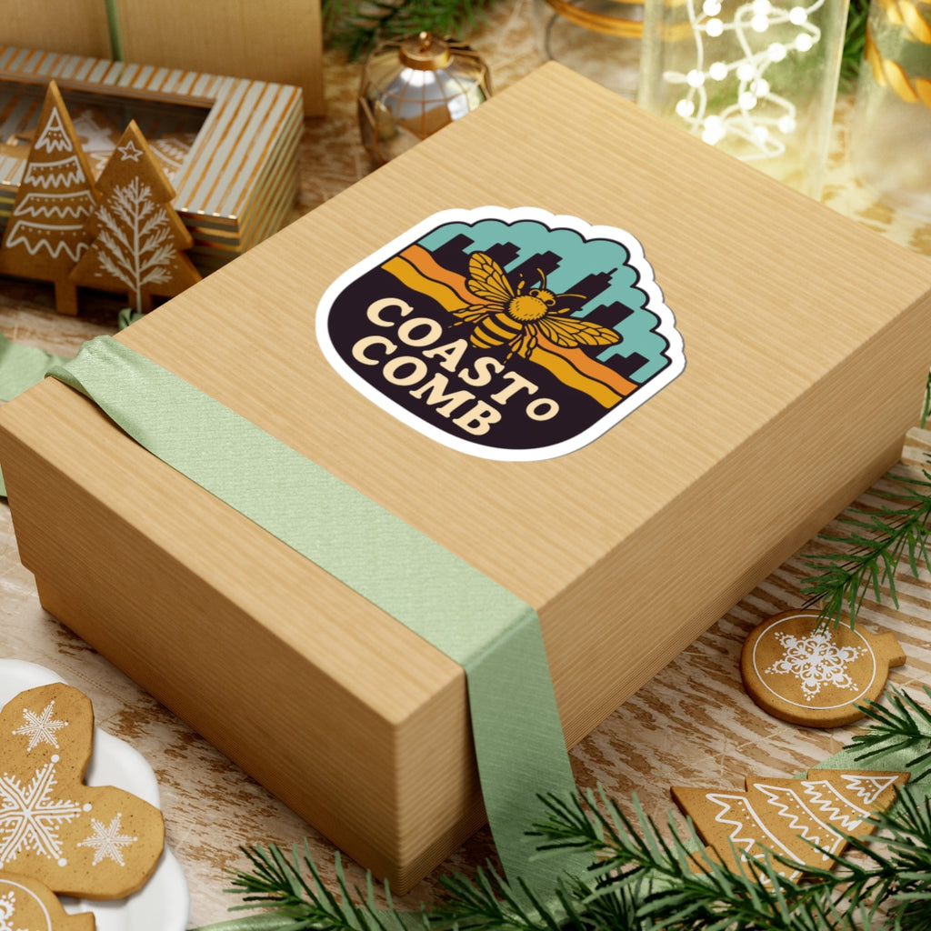 Wooden gift box with a 'Coastal Comb' logo on a festive background with cookies and greenery.